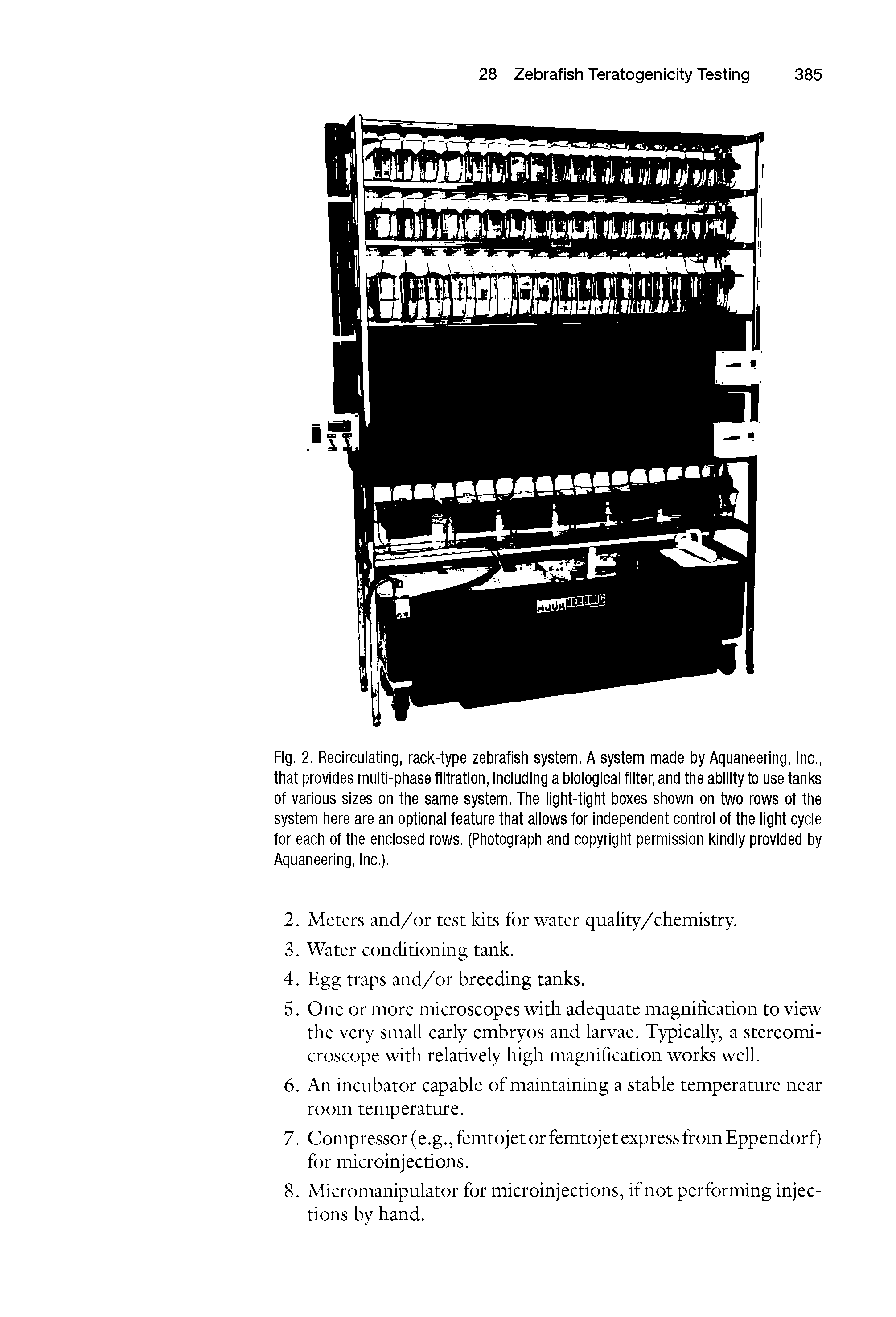 Fig. 2. Recirculating, rack-type zebrafish system. A system made by Aquaneering, Inc., that provides multi-phase filtration, including a biological filter, and the ability to use tanks ot various sizes on the same system. The light-tight boxes shown on two rows ot the system here are an optional feature that allows for independent control of the light cycle tor each ot the enclosed rows. (Photograph and copyright permission kindly provided by Aquaneering, Inc.).