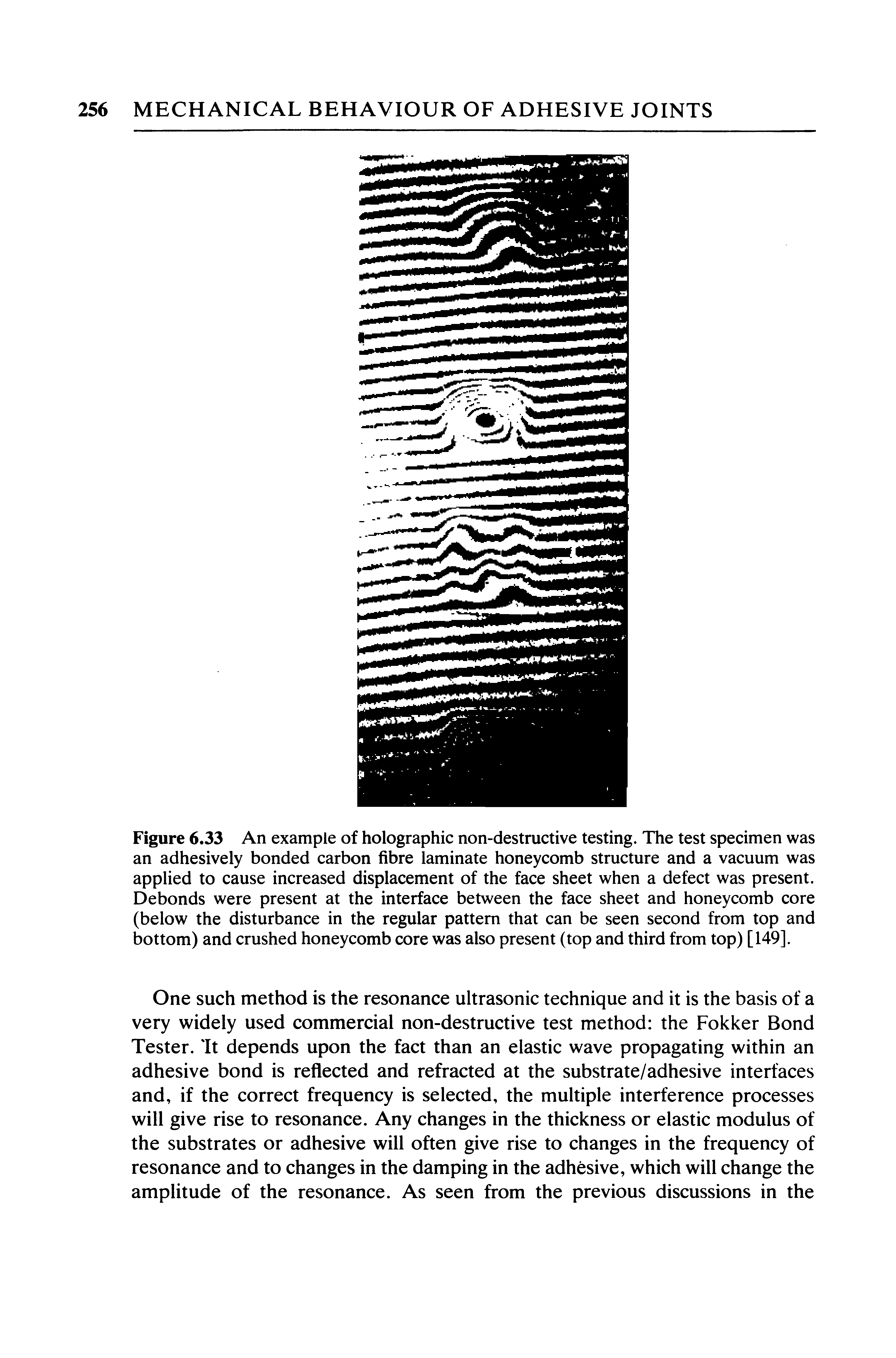 Figure 6.33 An example of holographic non-destructive testing. The test specimen was an adhesively bonded carbon fibre laminate honeycomb structure and a vacuum was applied to cause increased displacement of the face sheet when a defect was present. Debonds were present at the interface between the face sheet and honeycomb core (below the disturbance in the regular pattern that can be seen second from top and bottom) and crushed honeycomb core was also present (top and third from top) [149].