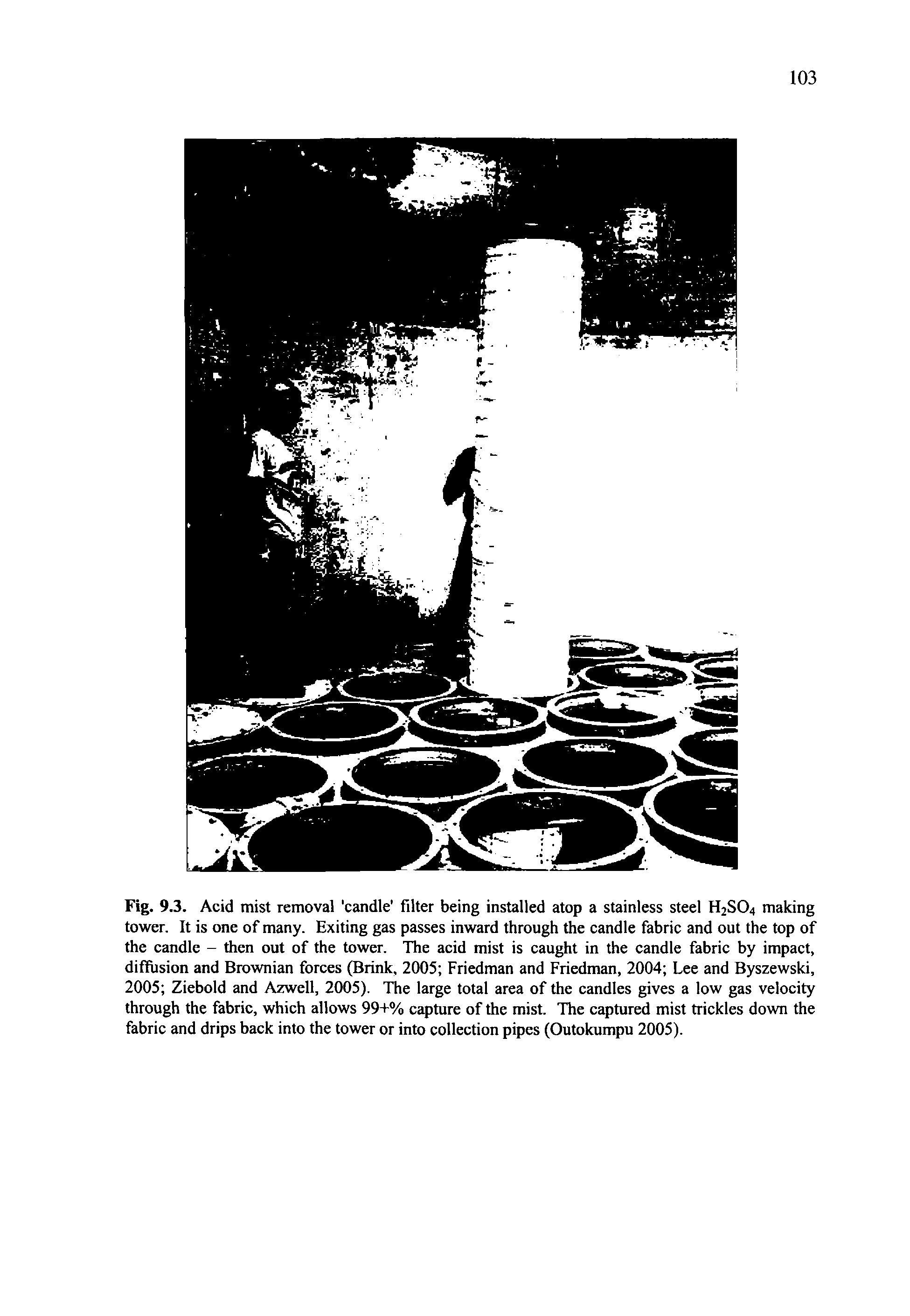 Fig. 9.3. Acid mist removal candle filter being installed atop a stainless steel H2SO4 making tower. It is one of many. Exiting gas passes inward through the candle fabric and out the top of the candle - then out of the tower. The acid mist is caught in the candle fabric by impact, diffusion and Brownian forces (Brink, 2005 Friedman and Friedman, 2004 Lee and Byszewski, 2005 Ziebold and Azwell, 2005). The large total area of the candles gives a low gas velocity through the fabric, which allows 99+% capture of the mist. The captured mist trickles down the fabric and drips back into the tower or into collection pipes (Outokumpu 2005).